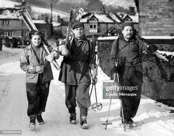 Mr and Mrs J. G. Clarke and Mr J. Middleton all of Sheffield setting off from the Village of Edale armed with their ski-ing tackle. February 1954.