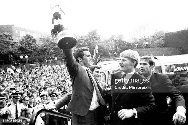 Bob Moncur holds the Inter-Cities Fairs Cup aloft at St James' Park during Newcastle United's homecoming parade. 12th June, 1969.