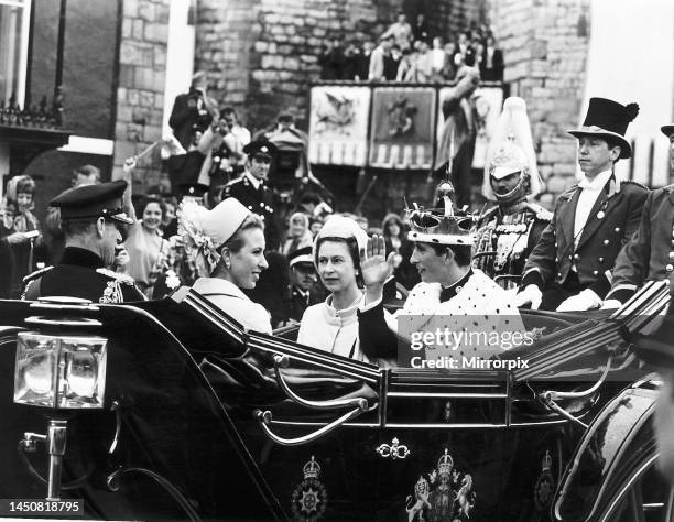 Prince Charles wearing his coronet and robes, the newly invested Prince of Wales drives away from the castle after the ceremony. Also in the carriage...