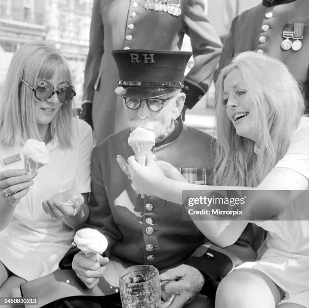 Waitress from the Chelsea Drugstore share an ice cream and a pint with some Chelsea pensioners to celebrate the drugstores first year in business in...