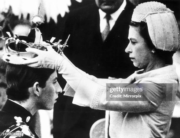 Queen Elizabeth II places the crown on the head of Prince Charles in July 1969. The Investiture of Prince Charles at Caernarfon.