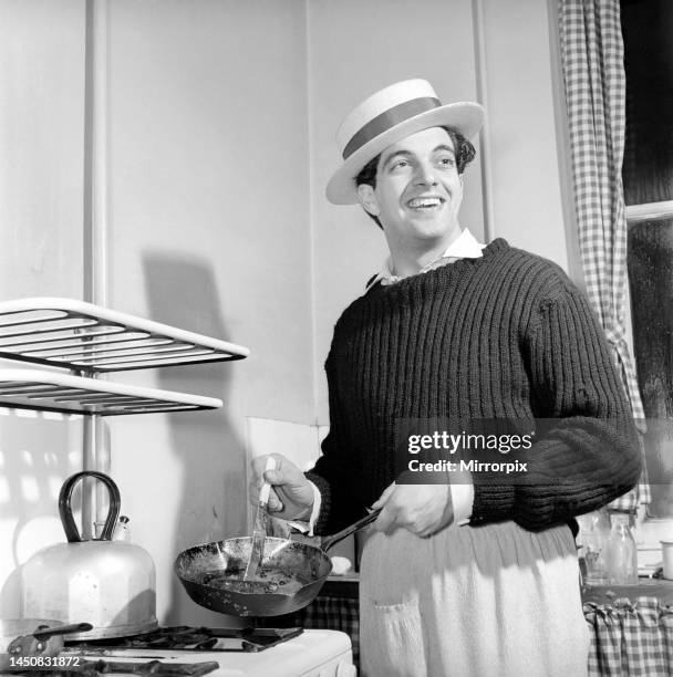 Singer Frankie Vaughan seen here at home cooking breakfast for his family, circa 1957.