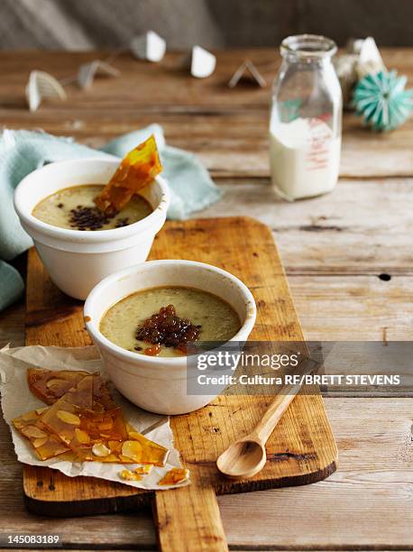 bowl of custard with nut brittle - カスタード ストックフォトと画像