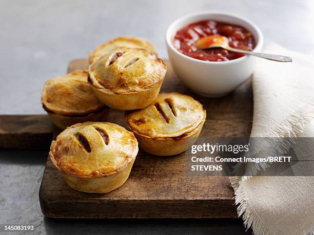 platter of pies and sauce - meat pie stockfoto's en -beelden