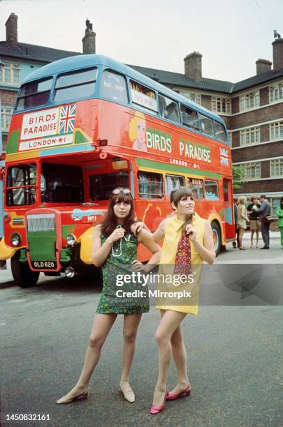 Models pose in front of a bus painted with the slogan Birds Paradise wearing mini dresses by designer Paco Rabanne at Salford in aid of Women's...