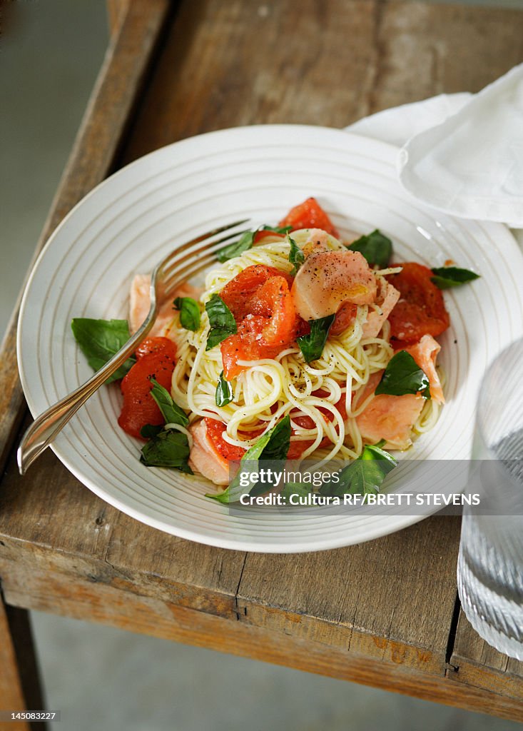 Plate of fish and tomato pasta