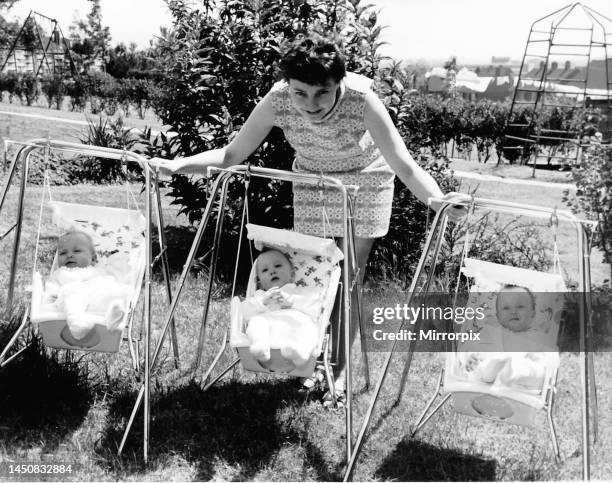 Sheila Thorns with her three babies , Britain's first surviving sextuplets. Picture of babies on swings being pushed by their mother. June 1969.