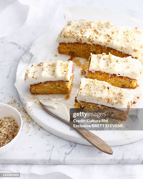 platter of frosted carrot cake - carrot cake stock pictures, royalty-free photos & images