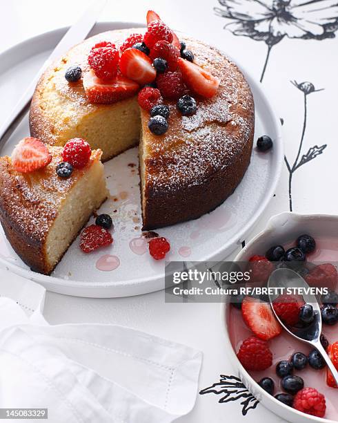 platter of rose cake with berry topping - cake stockfoto's en -beelden