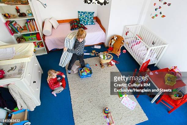 children cleaning up messy nursery - tidy room stock pictures, royalty-free photos & images