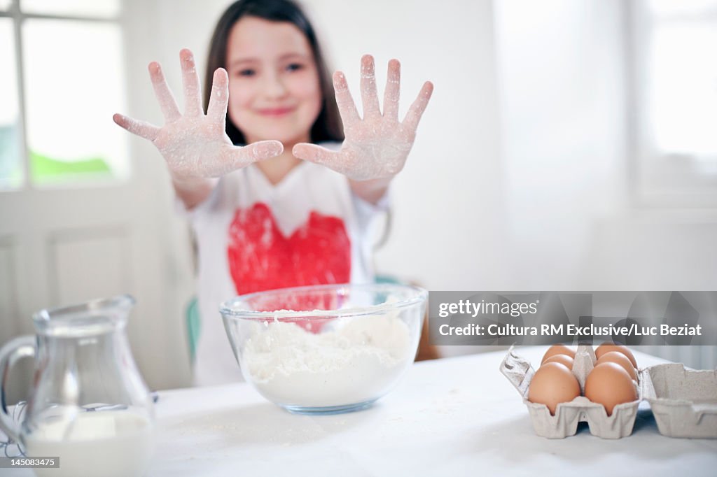 Smiling girl baking in kitchen