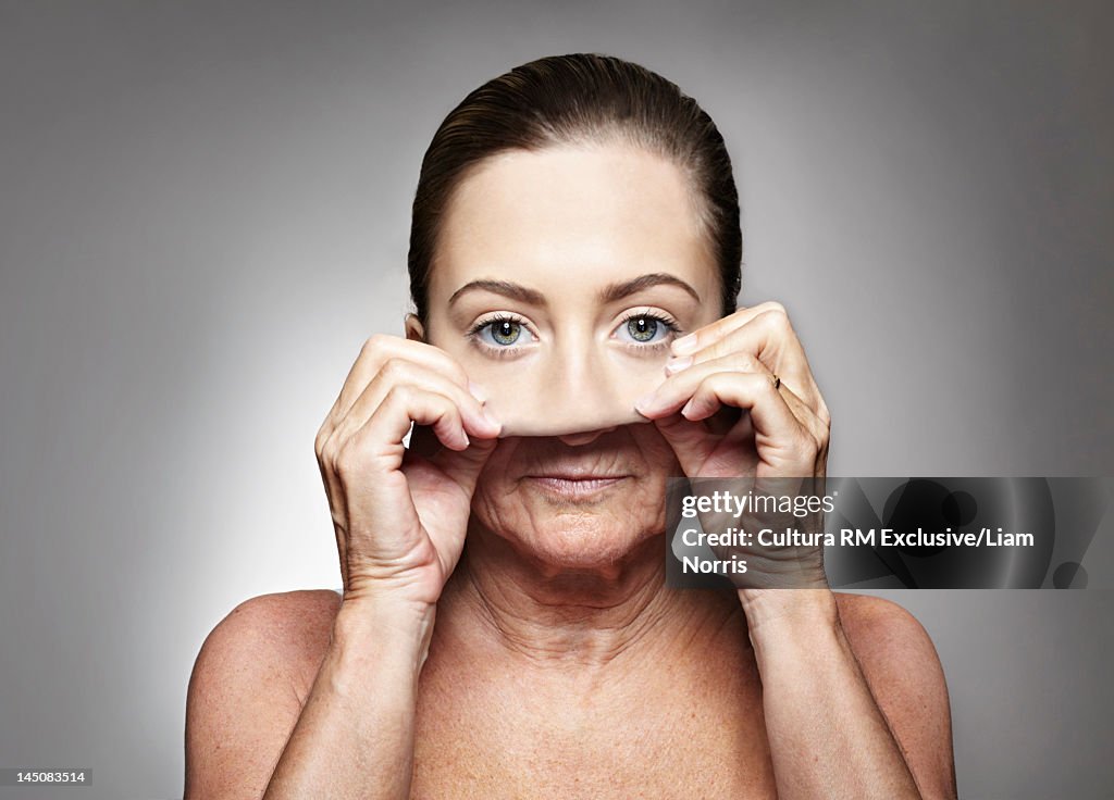 Older woman pulling on young mask