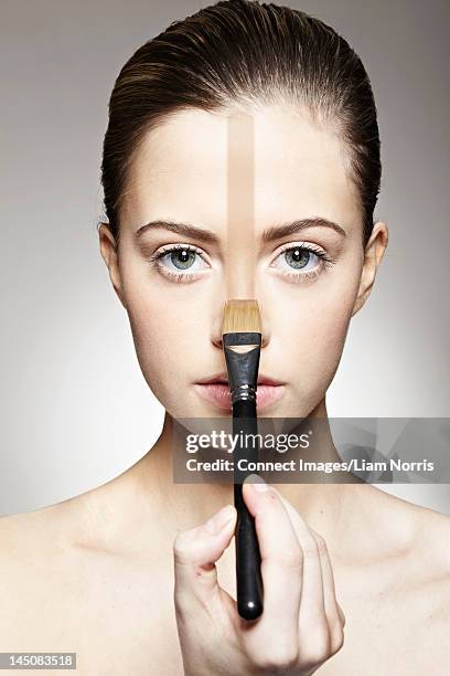 woman painting stripe on face - semi dress stock pictures, royalty-free photos & images