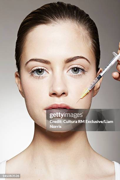 young woman having botox injection - beauty portrait studio shot stock pictures, royalty-free photos & images