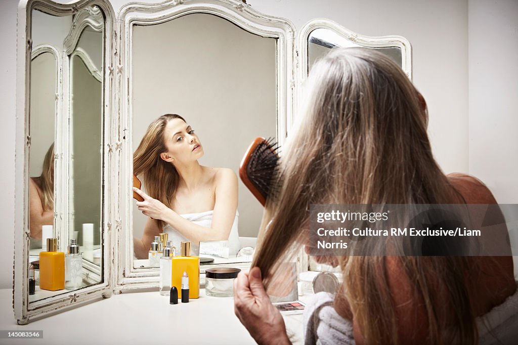 Woman seeing herself younger in mirror