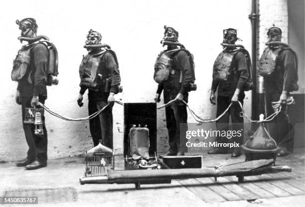 Rescue team with their equipment ready to descend the mine. Look at the strange headgear they wear, so that they can pass through the deadly gas,...