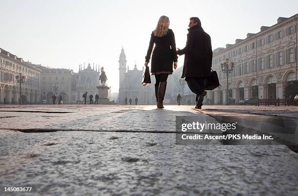 business couple walk through piazza, low view - italian women stock pictures, royalty-free photos & images