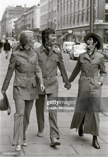 Ursula Klamet and Ken Swift in safari suits, with Paula Daly in a raincoat on Kings Road. 24th October 1969.