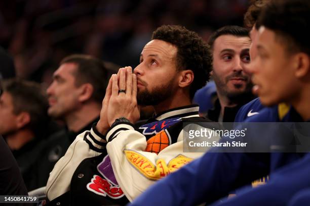 Stephen Curry of the Golden State Warriors looks on from the bench during the second quarter of the game against the New York Knicks at Madison...