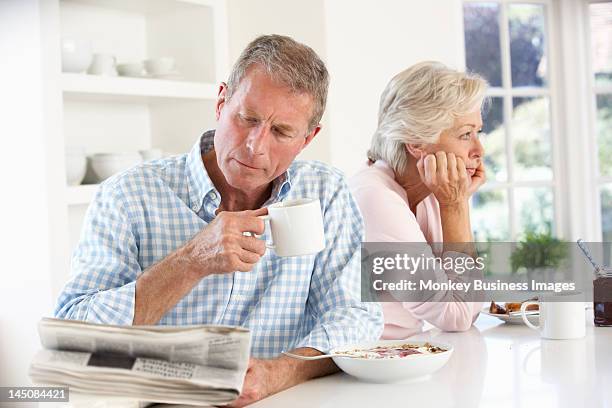 retired couple eating breakfast - ignore stockfoto's en -beelden