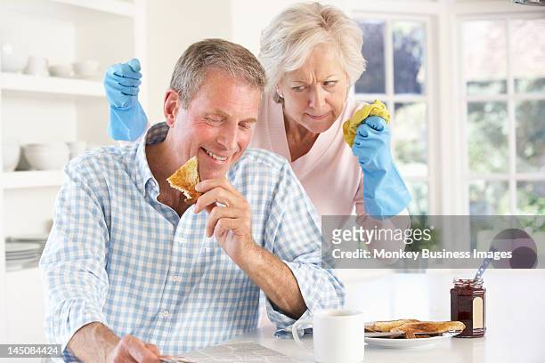 retired man not helping with housework - monkey eating paper stock pictures, royalty-free photos & images