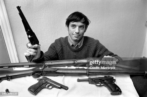 Brian Entwistle with his his collection of guns; a hand-reproduction cap and ball revolver, Brown Bess musket worth £80, an 1860 Enfield musket, A ....