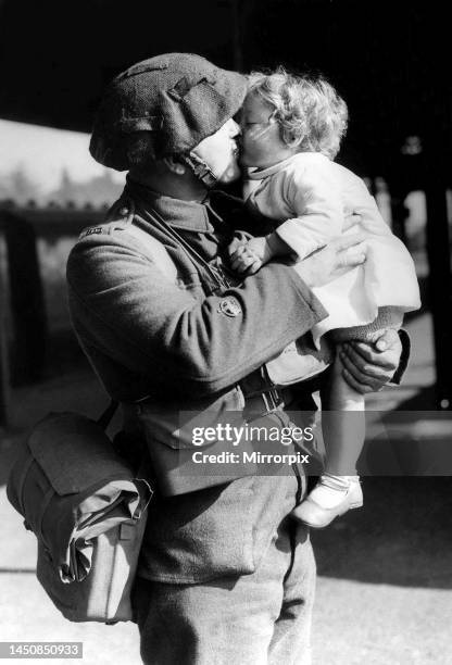 Soldier kisses his child goodbye as he leaves for war. October 1939.