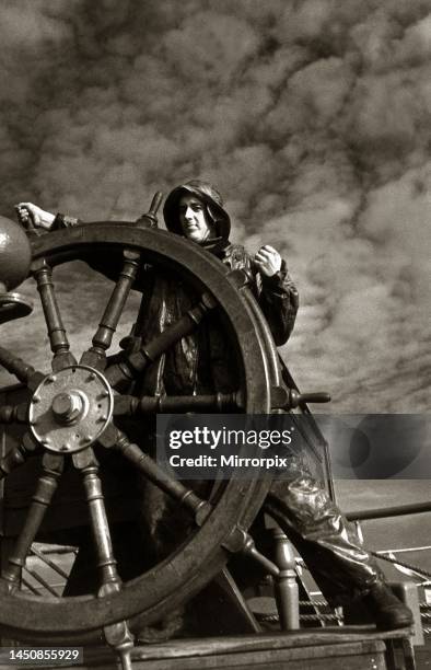 The three-masted barque Penang with sailor at the wheel, June 1935.