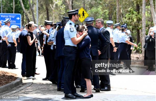 Young Police Officer is embraced as she shows her emotions on December 21, 2022 in Brisbane, Australia. Constable Rachel McCrow and Constable Matthew...