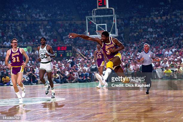 Magic Johnson of the Los Angeles Lakers passes against the Boston Celtics circa 1985 at the Boston Garden in Boston, Massachussetts. NOTE TO USER:...