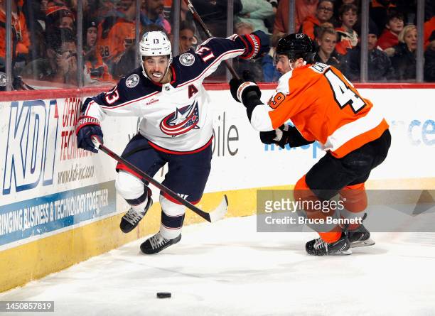 Johnny Gaudreau of the Columbus Blue Jackets spins away from Noah Cates of the Philadelphia Flyers during the third period at the Wells Fargo Center...