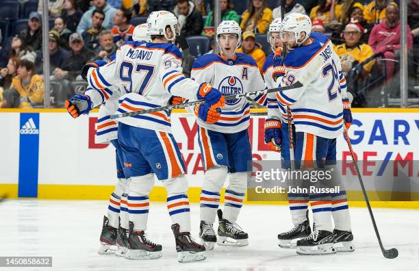 Connor McDavid celebrates a goal with Leon Draisaitl and Ryan Nugent-Hopkins of the Edmonton Oilers against the Nashville Predators during an NHL...