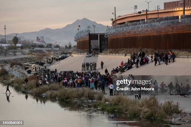 Texas National Guard troops block immigrants from entering a high-traffic border crossing area along Rio Grande in El Paso, Texas on December 20,...