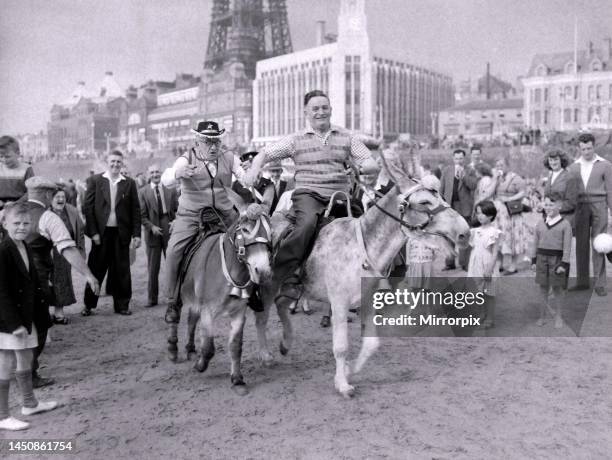 The old folks go young for a day. Two men racing donkey's on Blackpool beach. 17th June 1959.