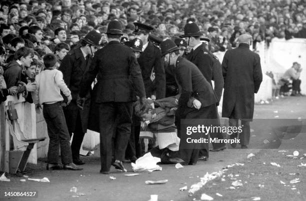 English League Division One match at Highfield Road. Coventry City versus Manchester United. A troublemaker is escorted out of the ground by police....