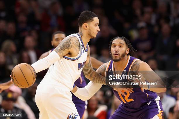 Kyle Kuzma of the Washington Wizards handles the ball against Ish Wainright of the Phoenix Suns during the first half of the NBA game at Footprint...
