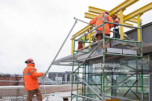 construction worker hands up scaffolding - scaffolding stock pictures, royalty-free photos & images