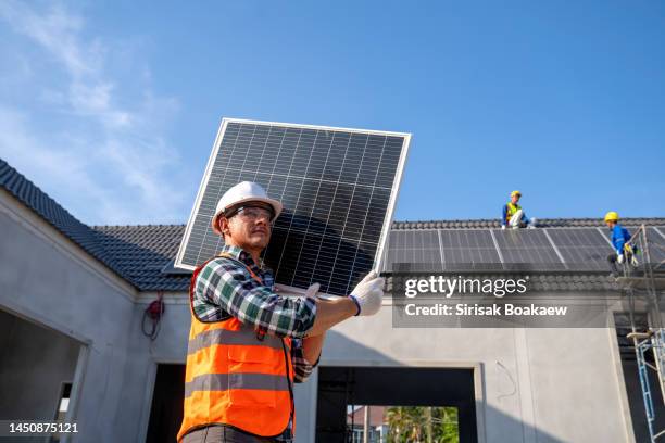 young technician standing on metal platform - solpanel bildbanksfoton och bilder