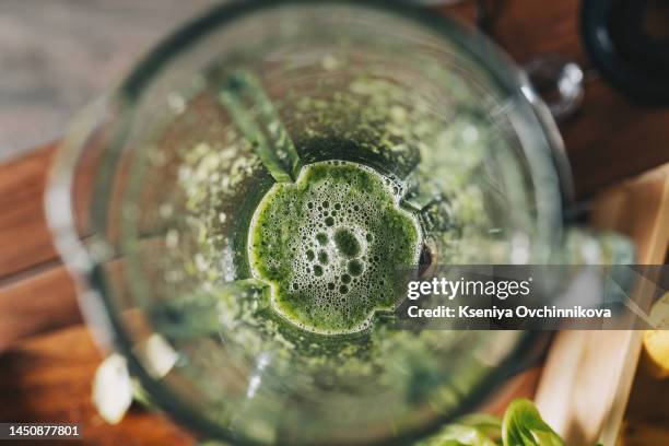 healthy green smoothie with banana, spinach, avocado and chia seeds in a glass bottles on a rustic background - cucumber cocktail stock pictures, royalty-free photos & images