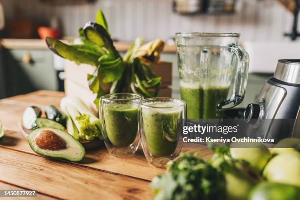 healthy green smoothie with banana, spinach, avocado and chia seeds in a glass bottles on a rustic background - blended drink stock pictures, royalty-free photos & images