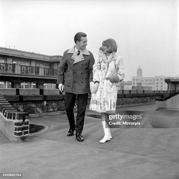 Hold hand gloves: Couple seen here modelling the hold hand gloves. 1960.