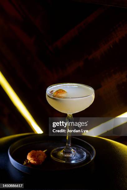 alcoholic cocktail in speakeasy style coupe glass - speakeasy stock pictures, royalty-free photos & images