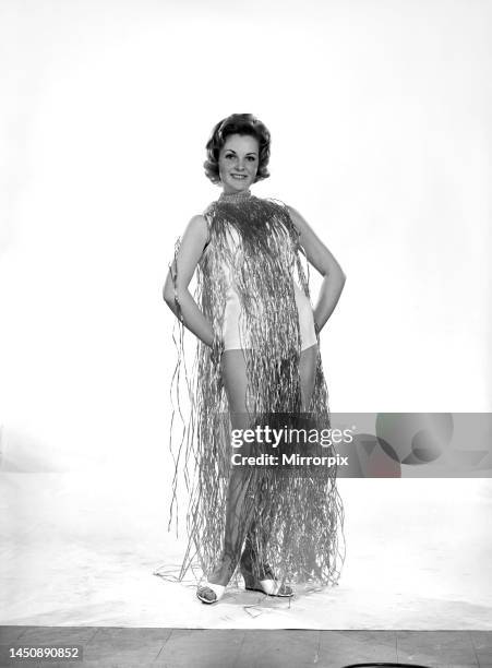 Roma Reeves wears a grass dress. Circa 1963.