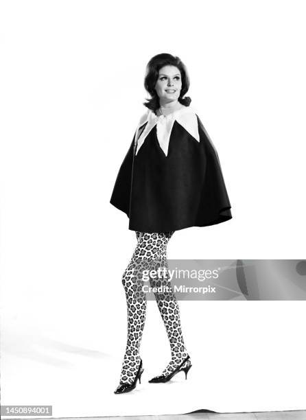 Gloria James modelling a skirt that can convert to a cape. June 1962.