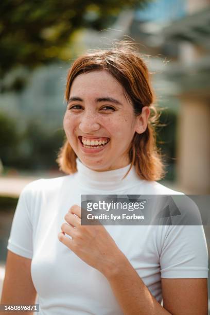 portrait of a young filipino woman roller skater in the city - filipino woman smiling stock pictures, royalty-free photos & images