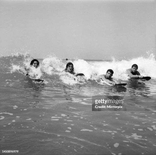 Women body boarding in the surf at Newquay June 1960.