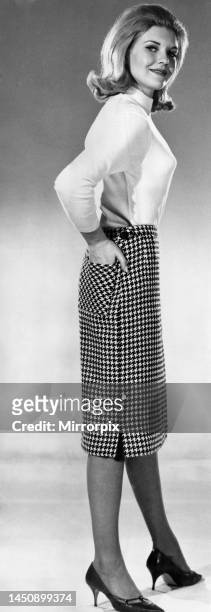 Maureen Walker modelling a check pencil skirt and a light sweater.