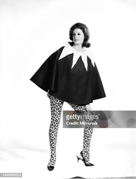Gloria James modelling a skirt that can convert to a cape. June 1962.