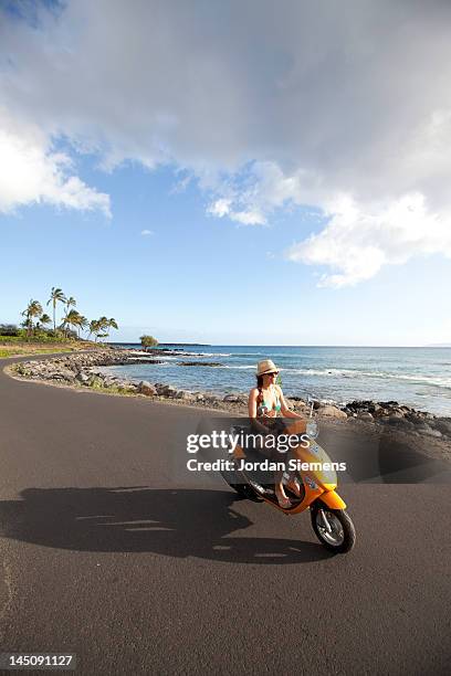 woman riding a scooter on a tropica island. - moped stock-fotos und bilder