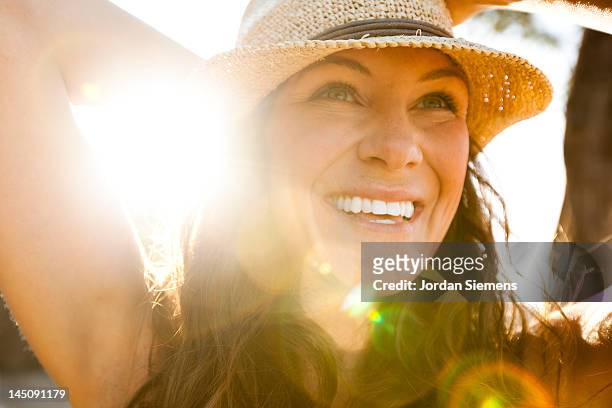 a female enjoying  a day at the beach. - sun hat stock pictures, royalty-free photos & images